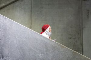 A person in a red hat visible on a diagonal concrete stairway.