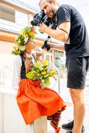 Photographer capturing images during a festive outdoor event.