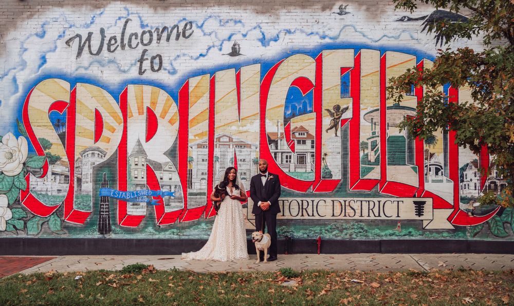 Newlyweds pose in front of colorful Springfield historic district wall mural in Jacksonville, Florida.