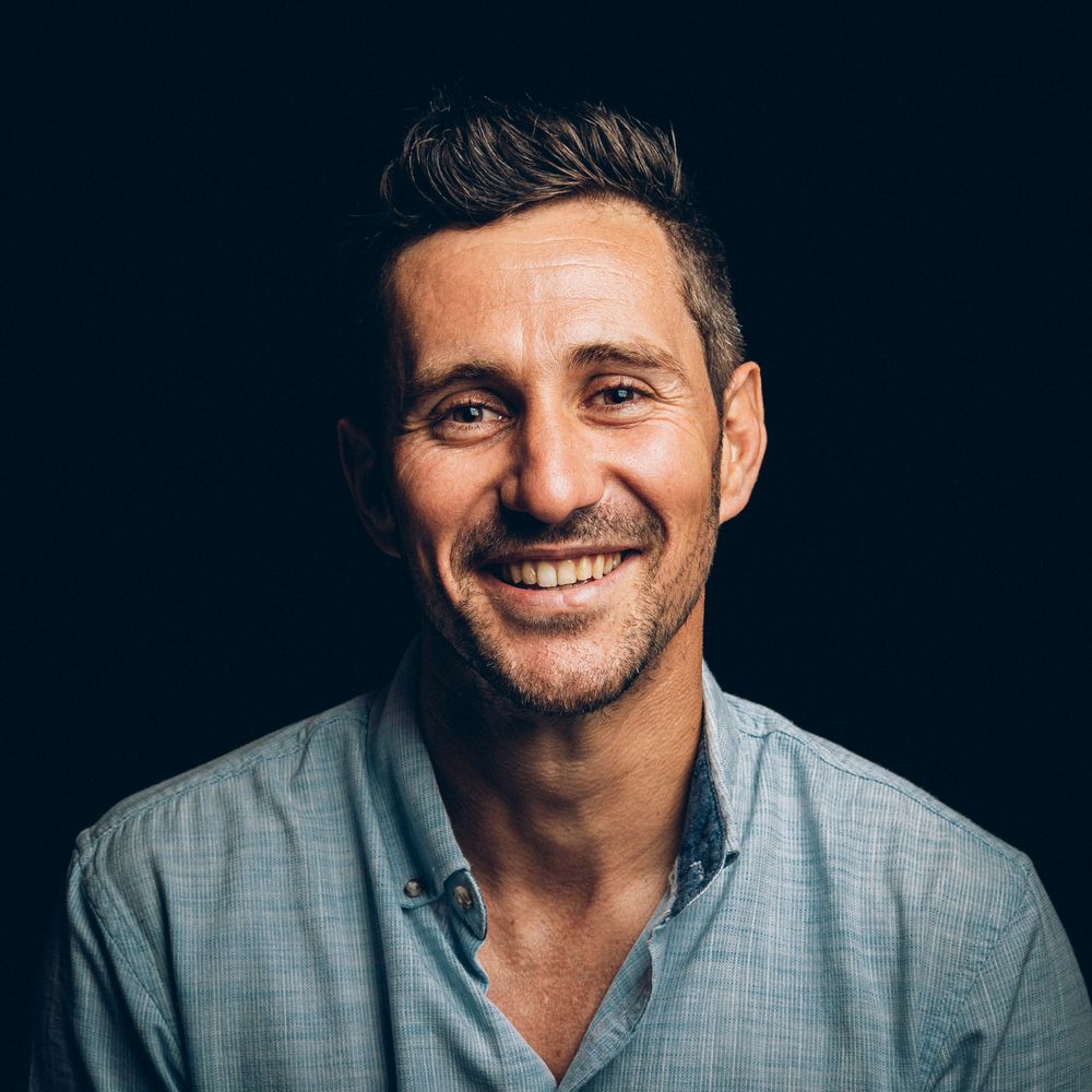 A headshot portrait series of someone in a grey button-down shirt against a dark background.
