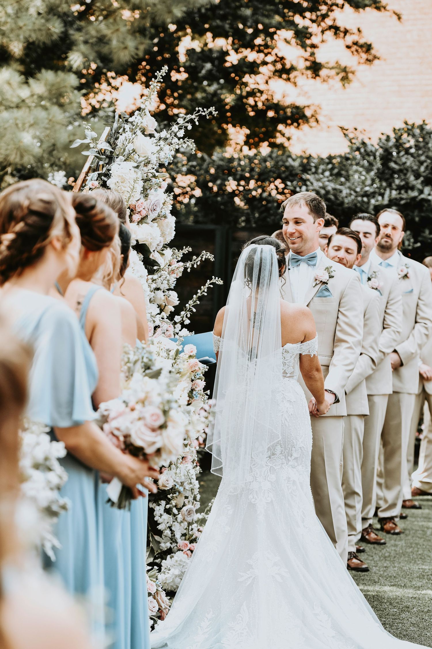 Caroline and Mike holding hands during outdoor ceremony in Fort Worth Stockyards