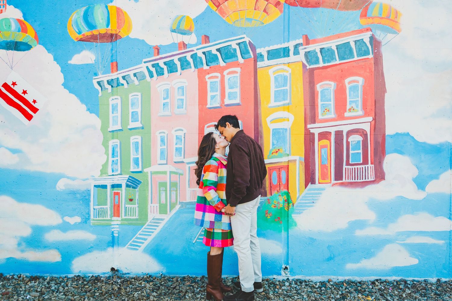 Colorful row houses painted as a vibrant mural create a whimsical urban streetscape against a bright blue sky in DC