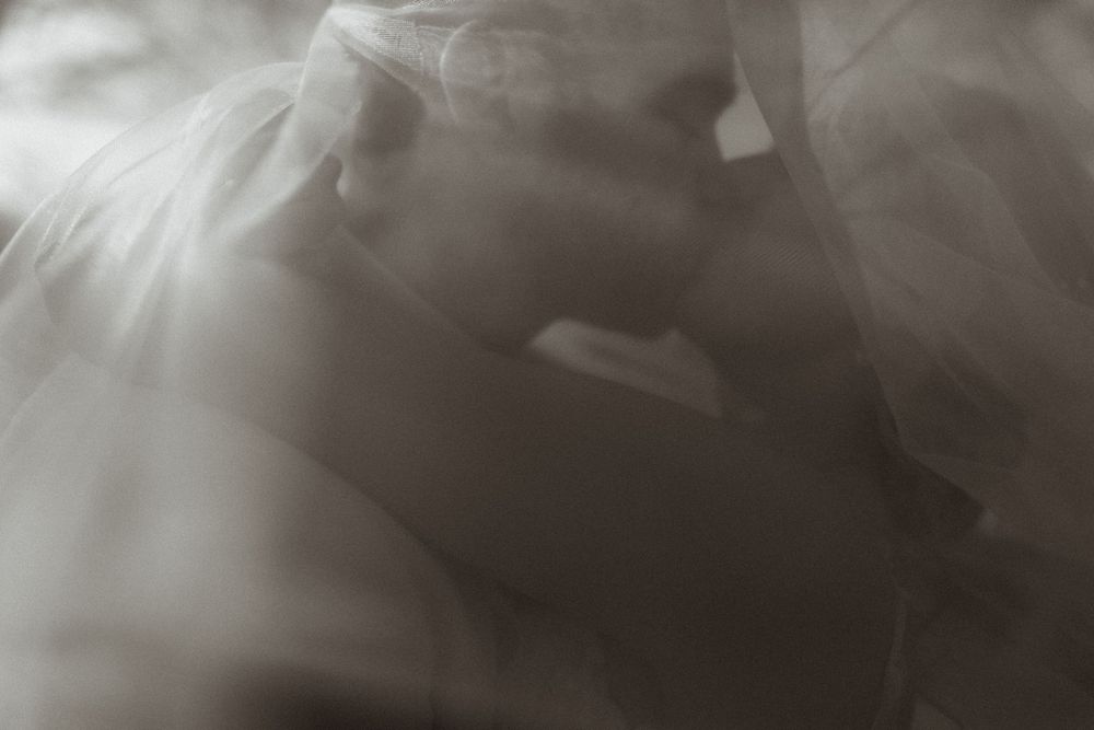 Abstract black and white photograph showing soft ethereal fabric textures with dreamy movement and blurred effects.