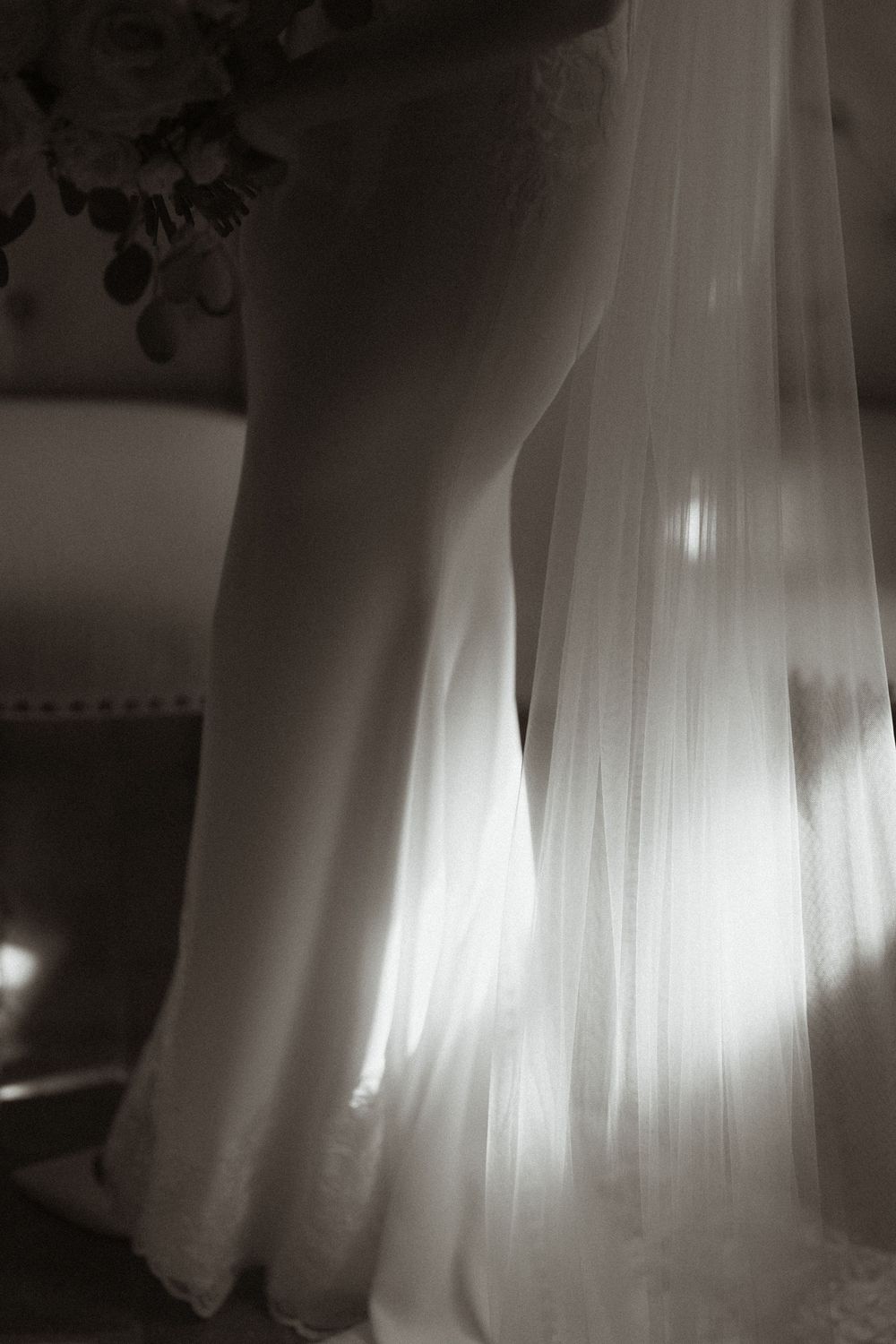 Multiple artistic silhouettes of dancing figures in white gowns against a dark background.