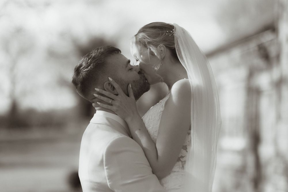 Black and white wedding photo collage showing tender kisses and romantic moments between bride and groom.