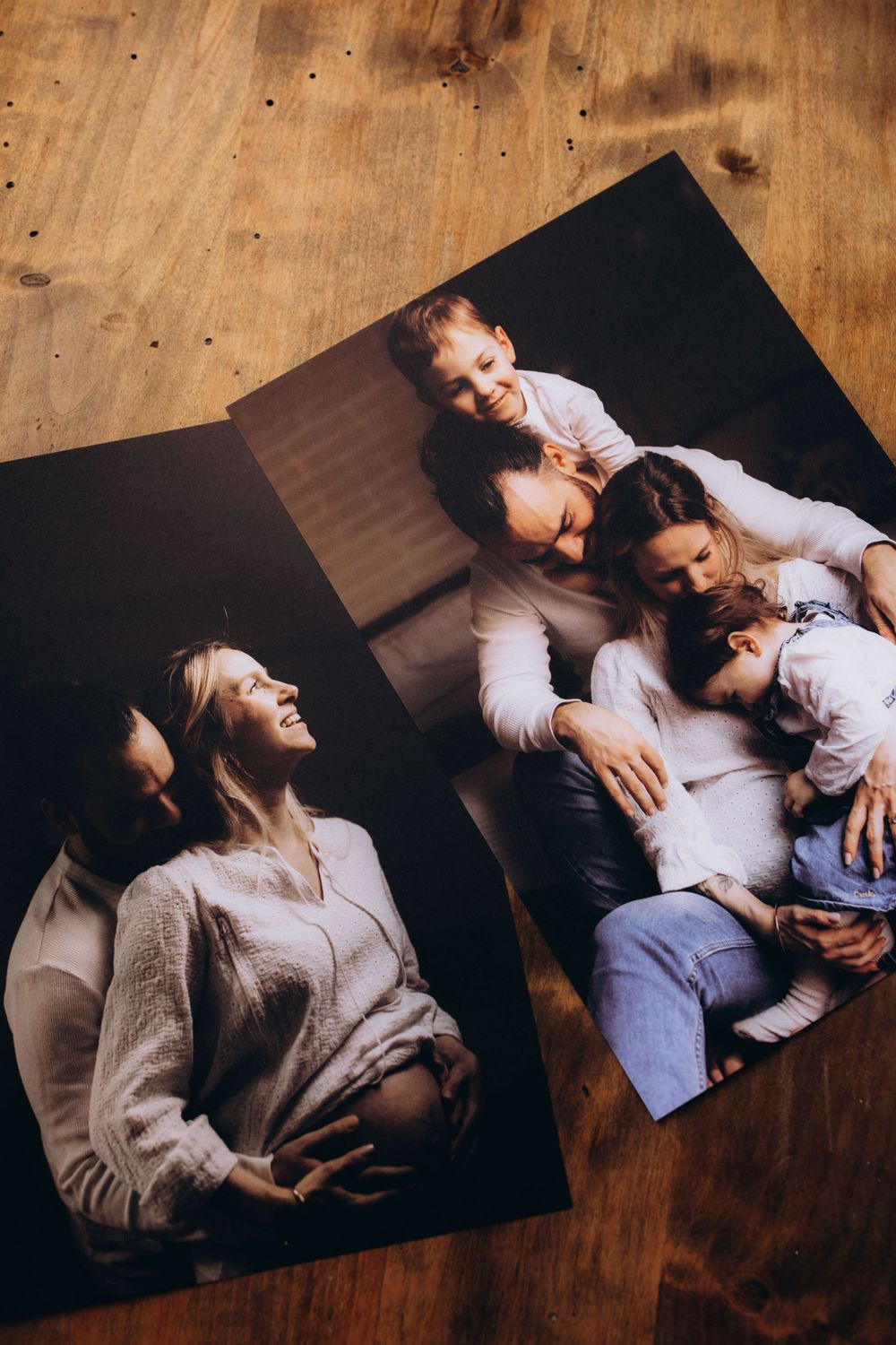 Two photographs showing a casual family moment displayed on wooden surface, highlighting intimate interaction.