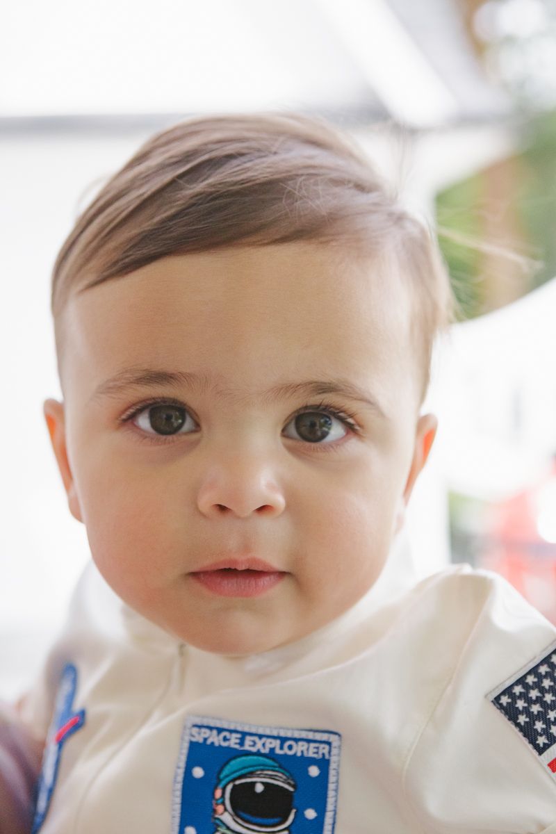 Joyful close-up of a baby boy celebrating his first birthday, beautifully captured by NYC family photographer Paula Brearley