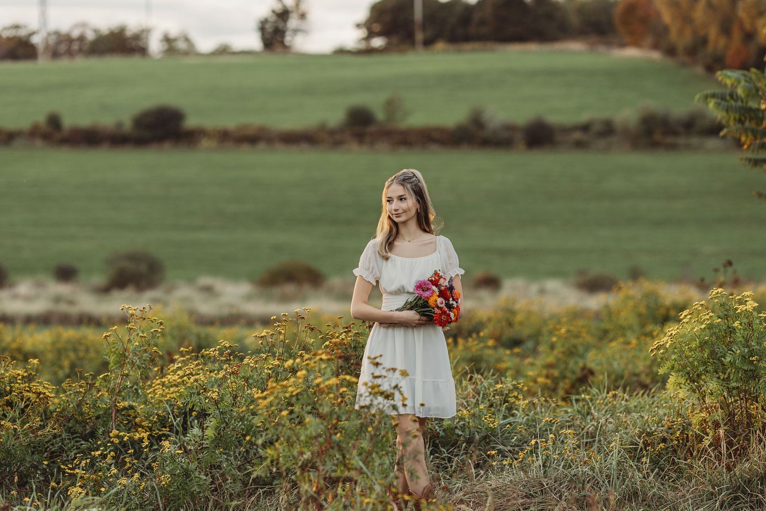 Professional senior photo of a girl in a flower field