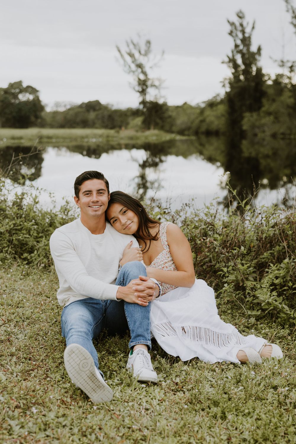 Woodsy couple photos at the West Delray Regional Park with a lake and tall trees during golden hour captured by Lindsay McDow Photography.