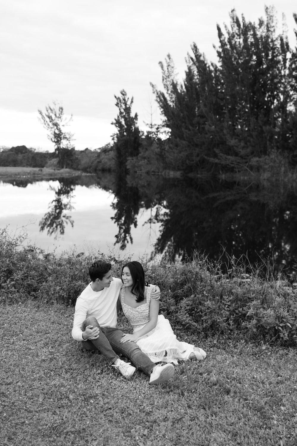Woodsy couple photos at the West Delray Regional Park with a lake and tall trees during golden hour captured by Lindsay McDow Photography.