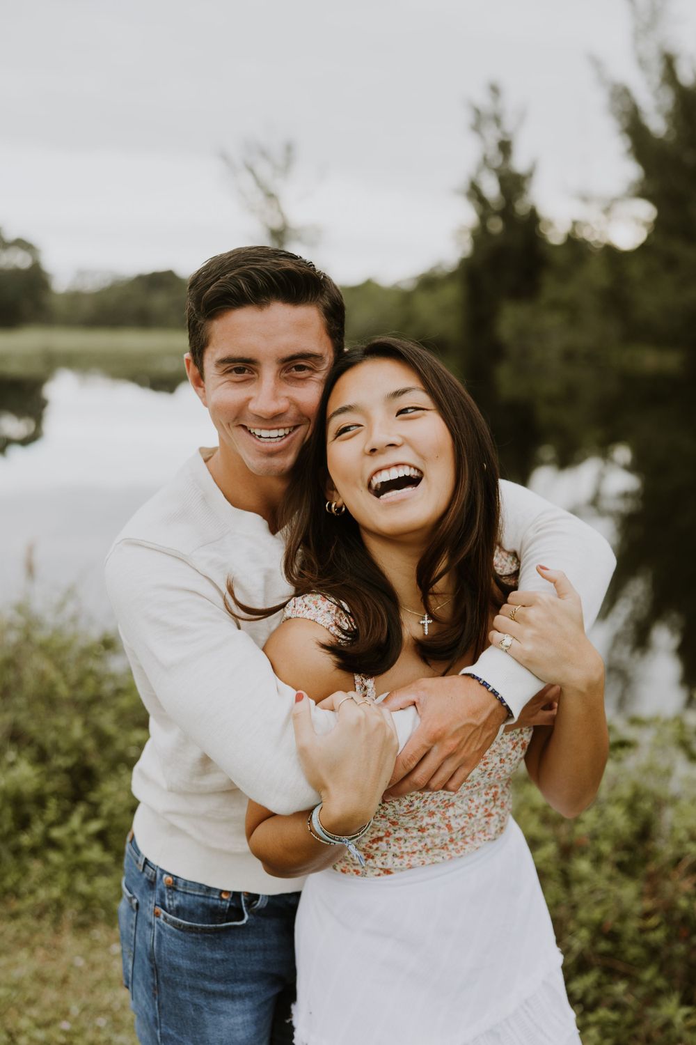 Woodsy couple photos at the West Delray Regional Park with a lake and tall trees during golden hour captured by Lindsay McDow Photography.