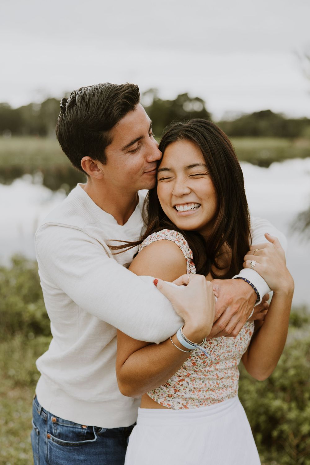 Woodsy couple photos at the West Delray Regional Park with a lake and tall trees during golden hour captured by Lindsay McDow Photography.