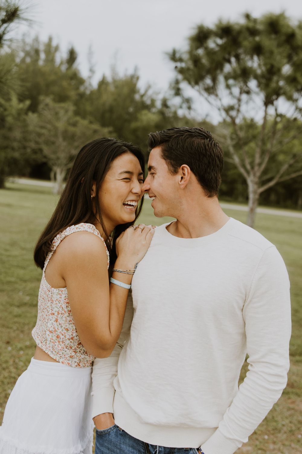 Woodsy couple photos at the West Delray Regional Park with a lake and tall trees during golden hour captured by Lindsay McDow Photography.