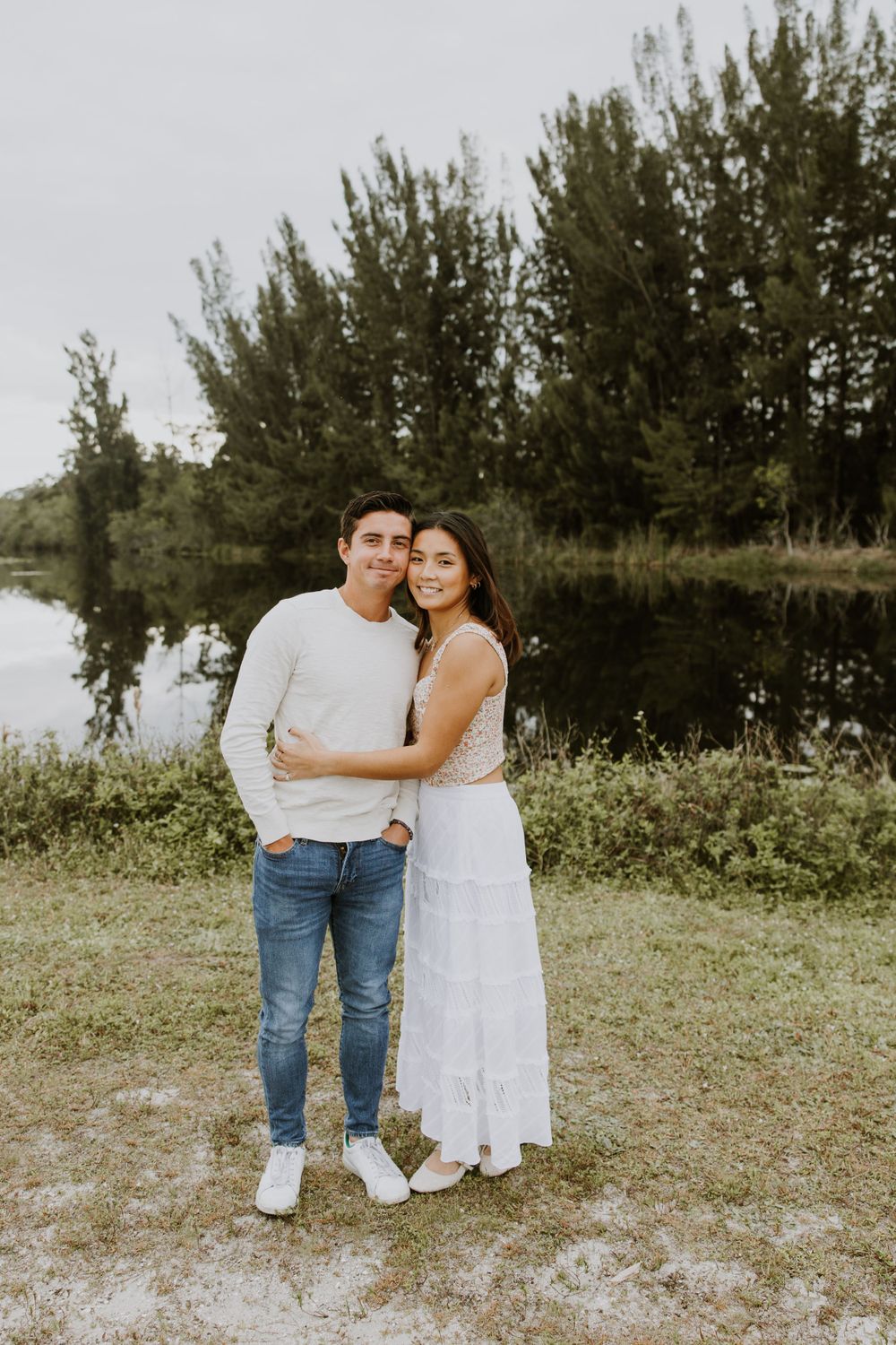 Woodsy couple photos at the West Delray Regional Park with a lake and tall trees during golden hour captured by Lindsay McDow Photography.