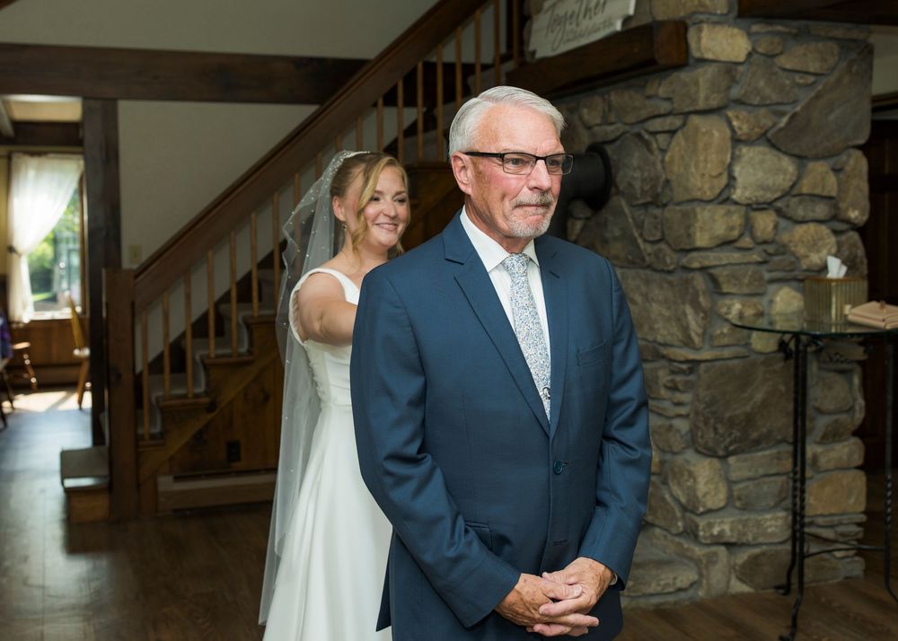 Interior wedding venue featuring rustic stone walls and wooden staircase details.
