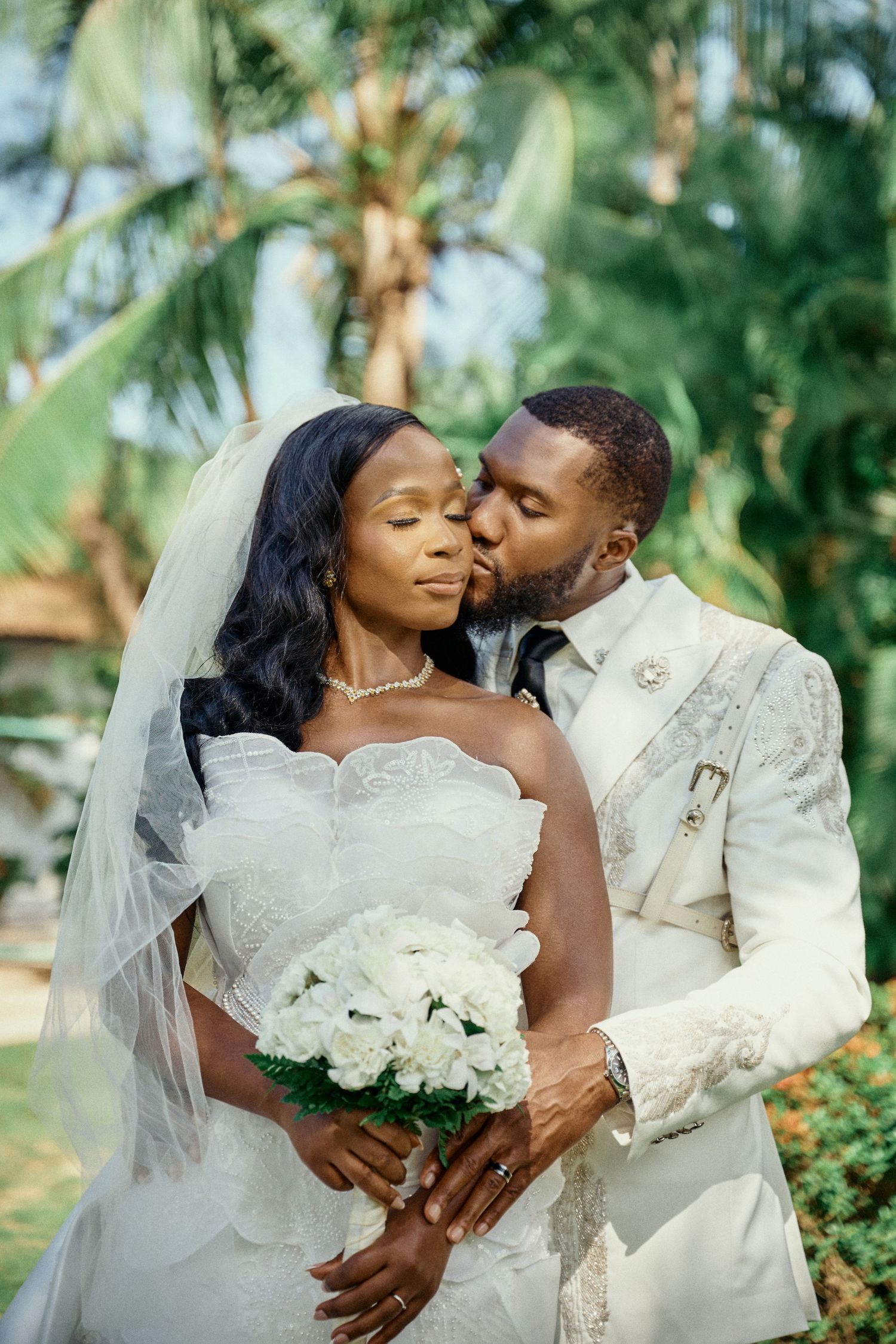 Rustic wooden wedding arch decorated with vibrant tropical flowers overlooks mountainous landscape. Jamaica Wedding Photographer