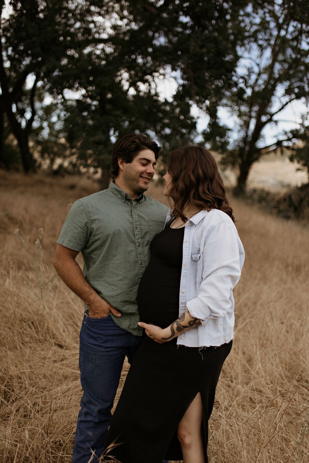 A couple shares an intimate moment together in a field of golden grass during sunset in El Dorado Hills photoshoot