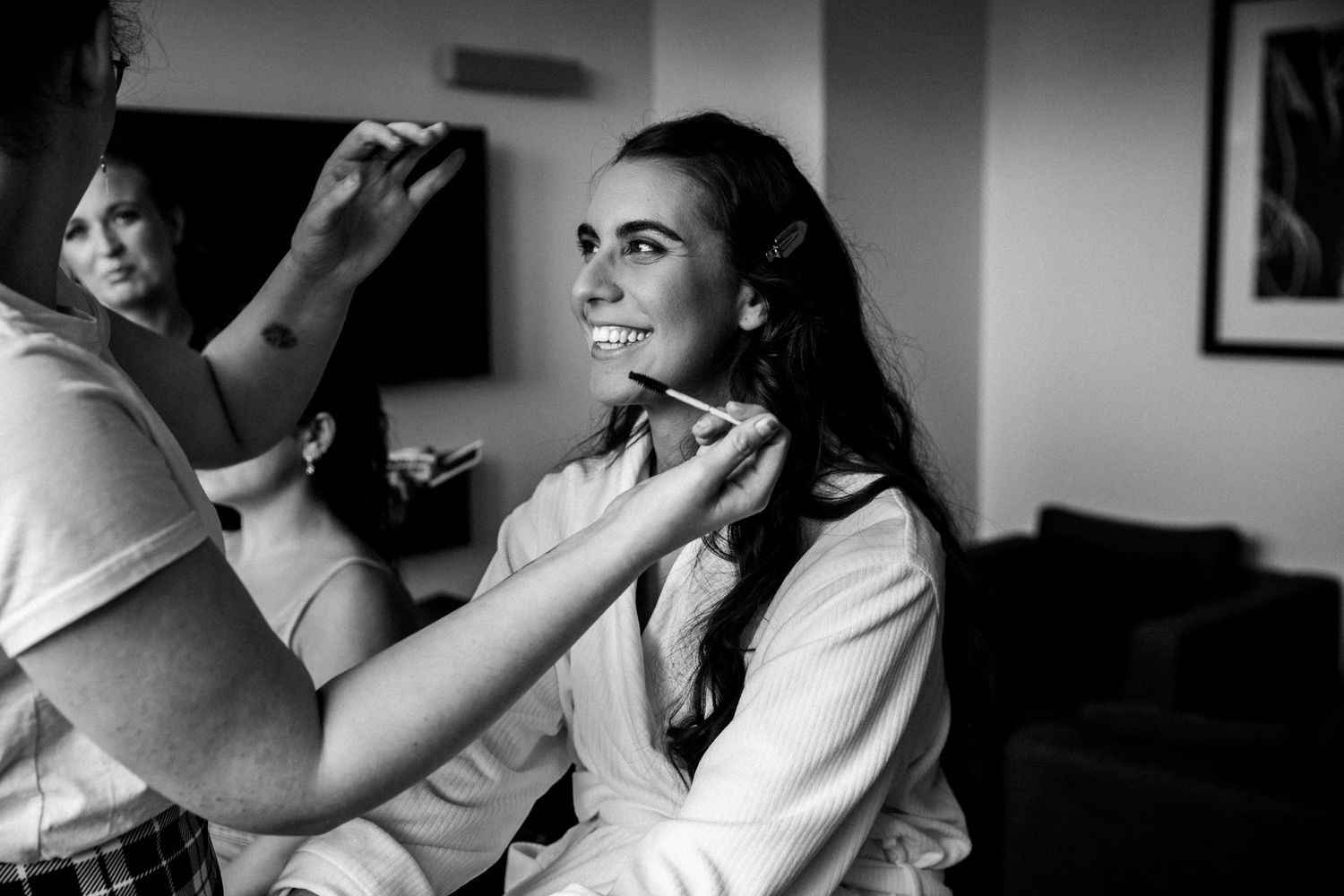 Black and white photo showing wedding day preparations in a cozy room.