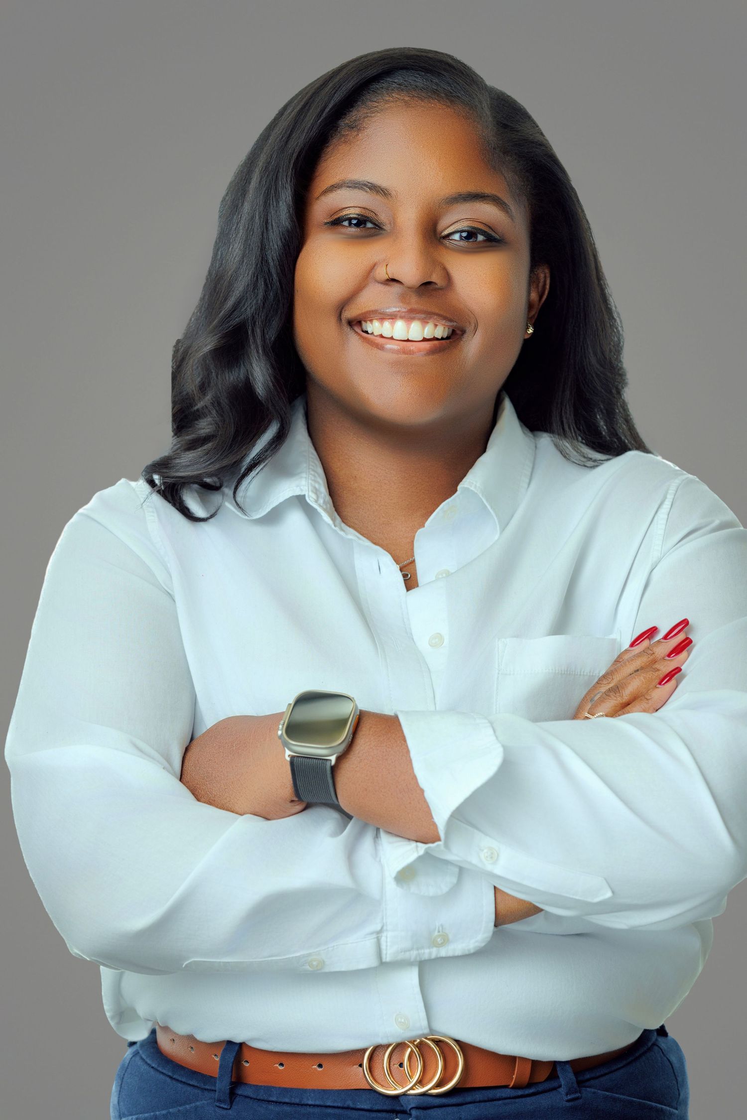 Professional headshot of a smiling woman with shoulder-length brown hair, wearing a blue blouse against a neutral background.