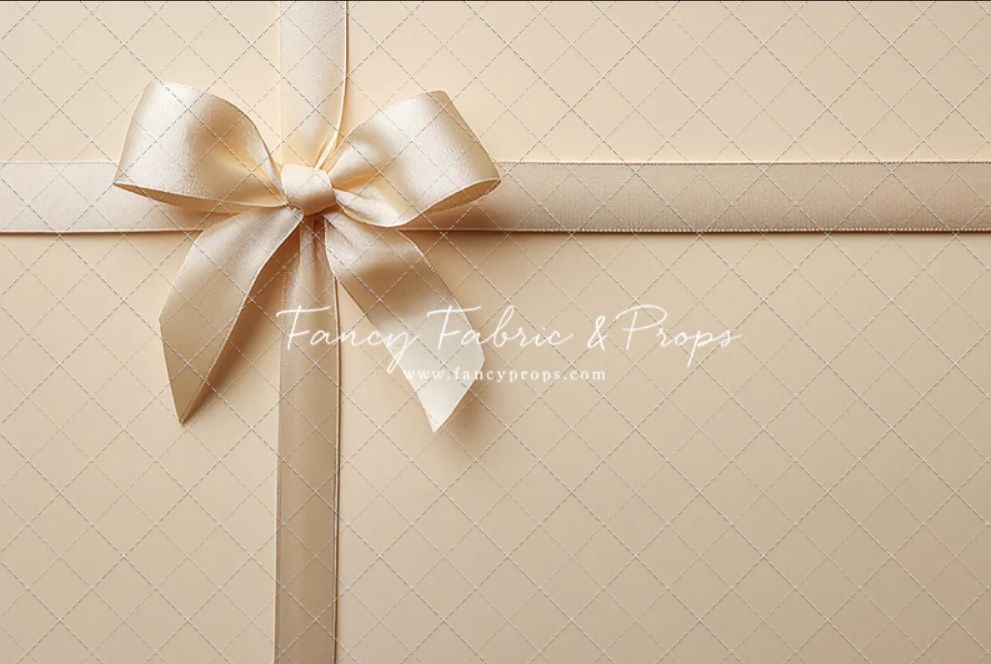 Elegant cream-colored gift box or package wrapped with a satin ribbon bow against a neutral background.