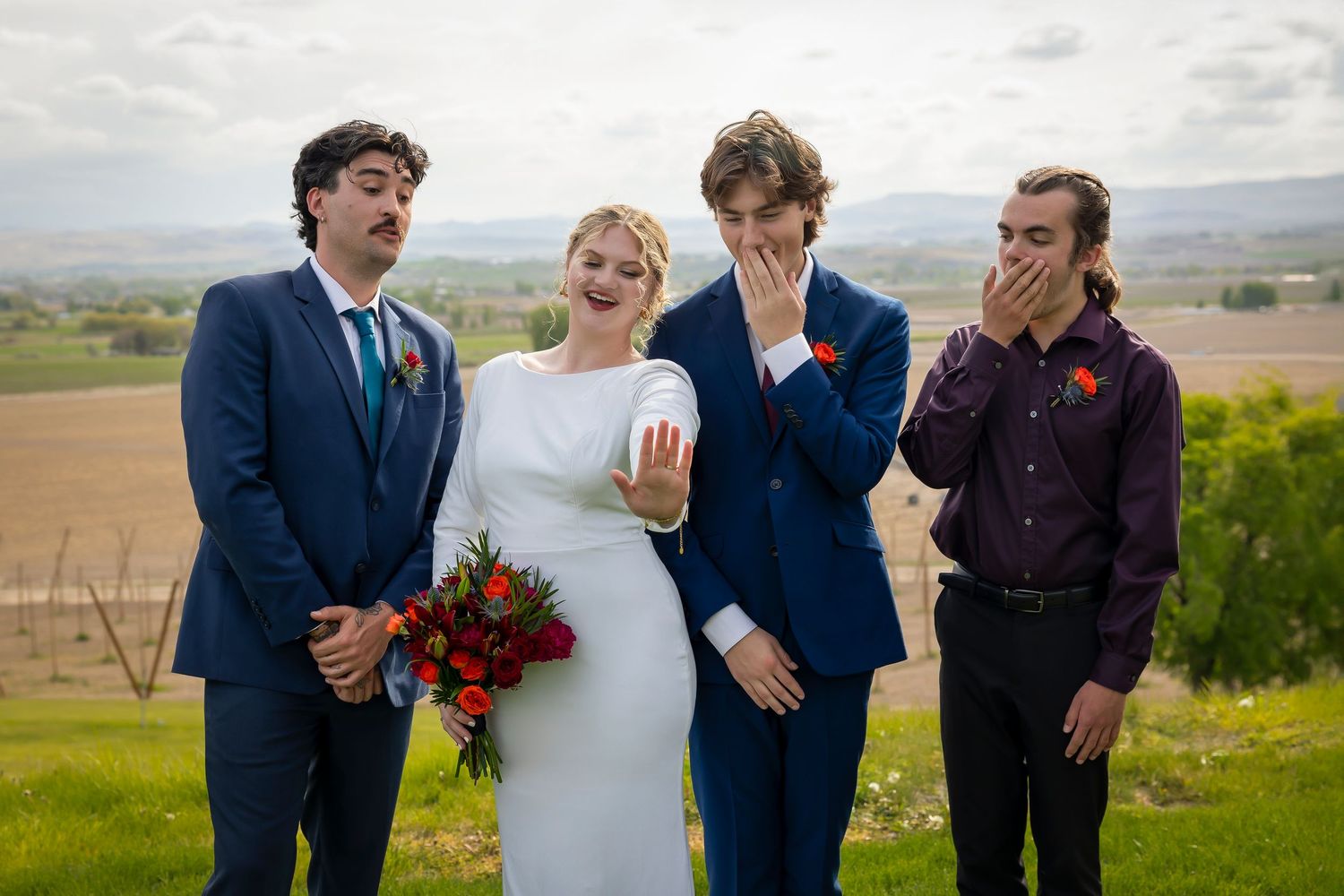 groomsmen with bride excited about her ring