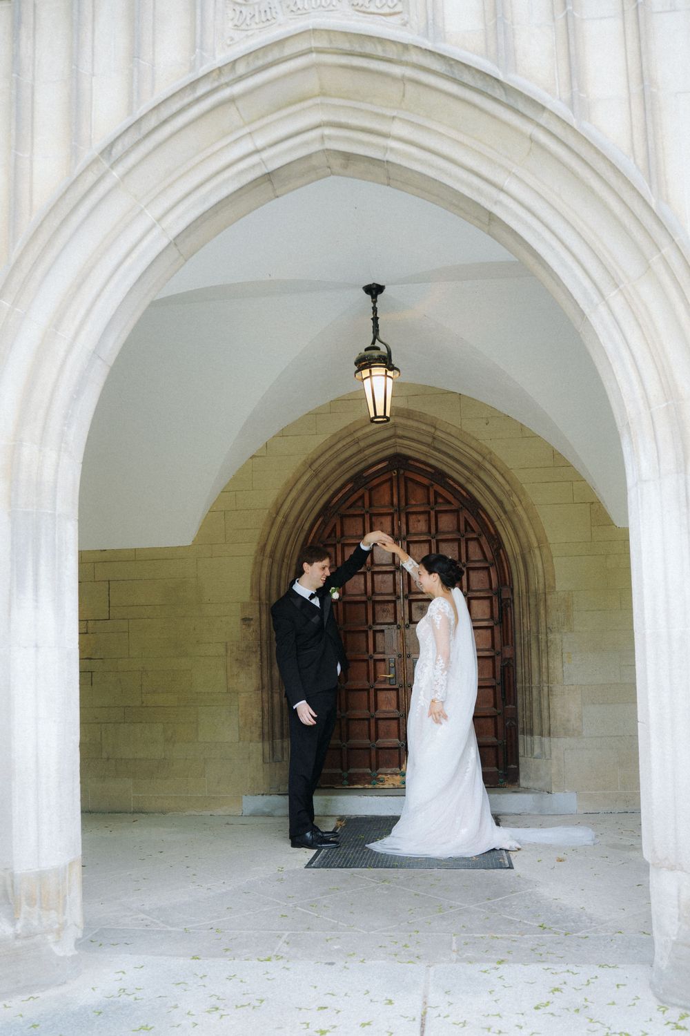 Romantic wedding portraits taken under arched cathedral doorways.