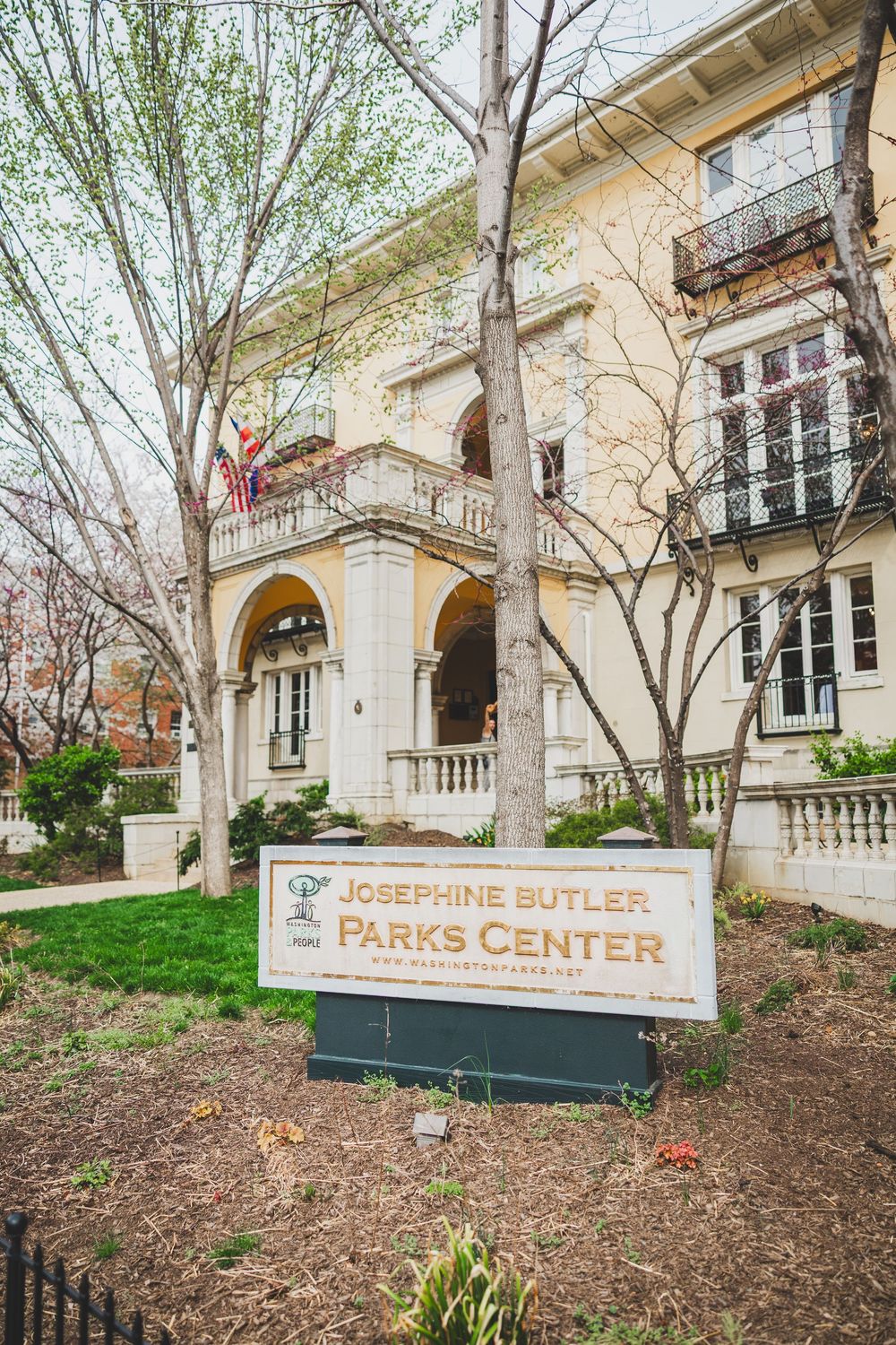 Signage sequence showing Parks Center and Josefine Butler building exterior with landscaping at a college campus.