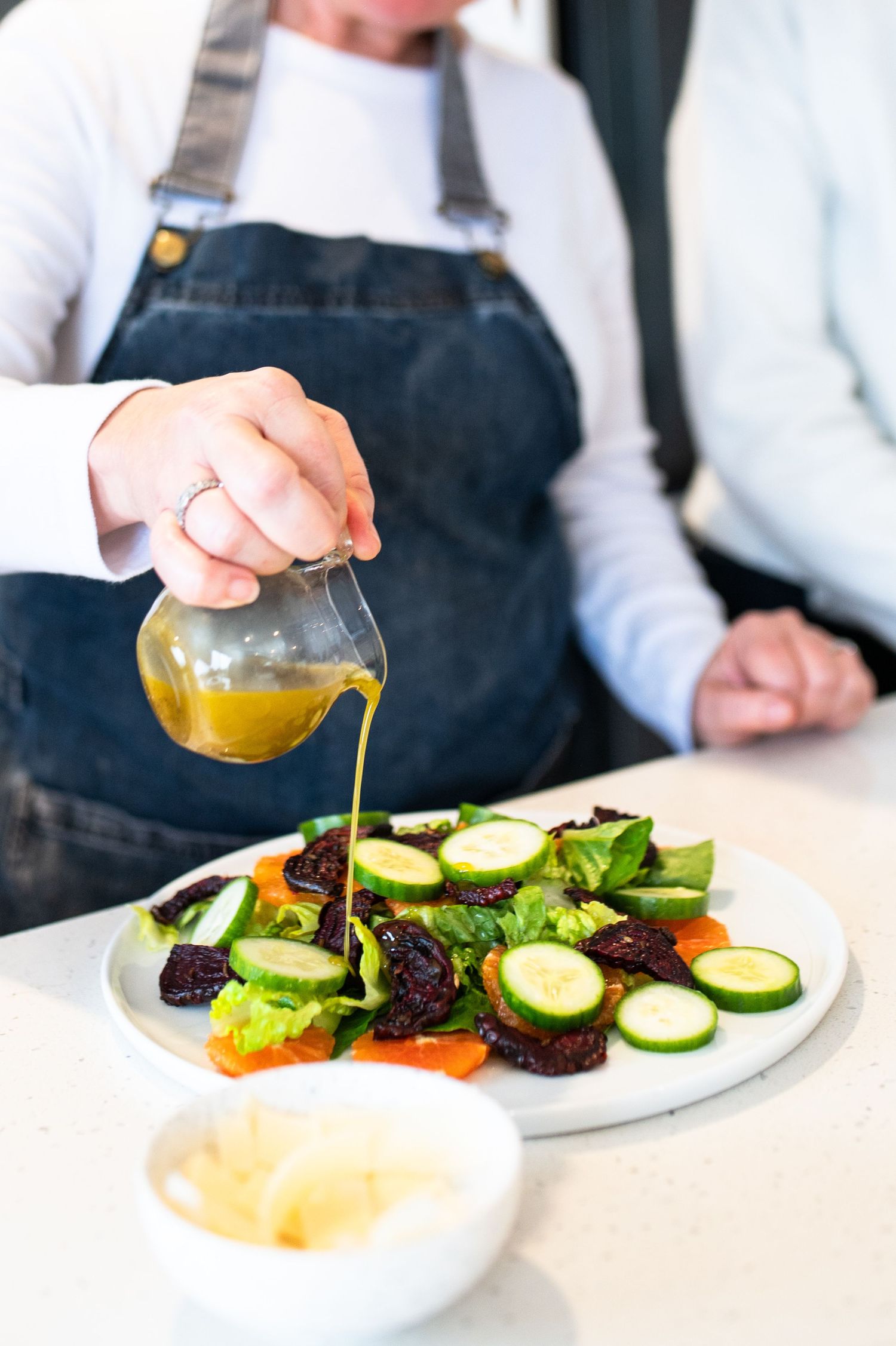Grilled zucchini slices seasoned with parmesan cheese and spices served on a white platter.