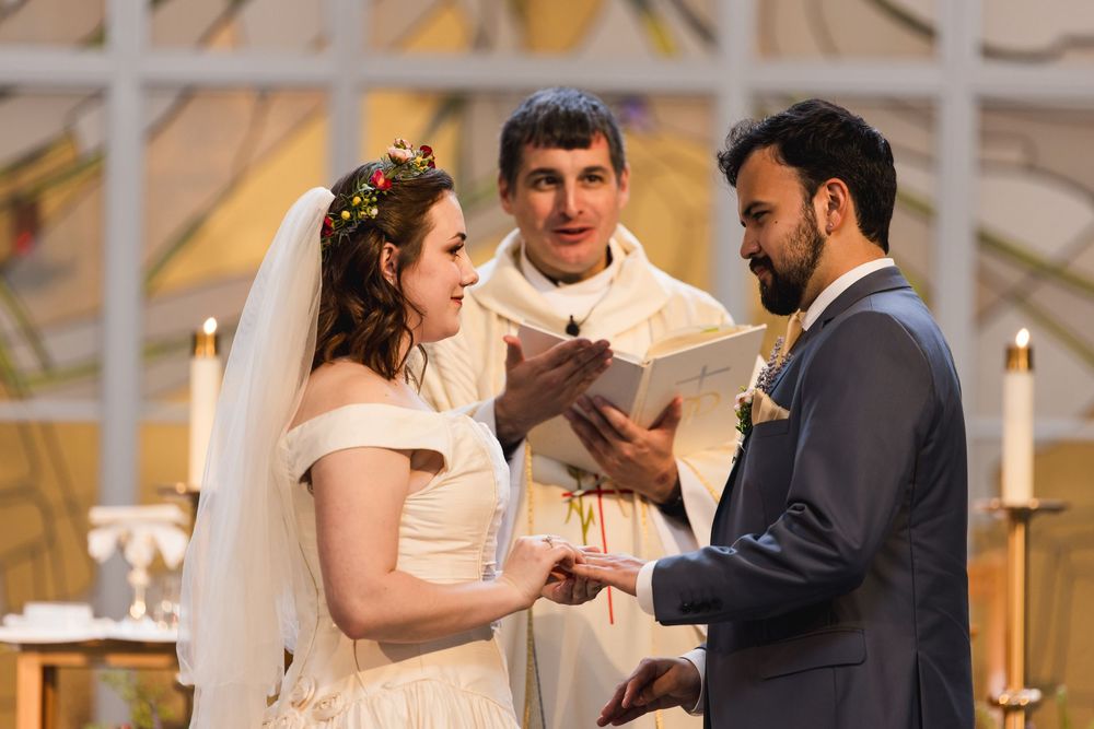 Happy couple shares their first dance at their wedding reception with warm mood lighting and flickering candles.