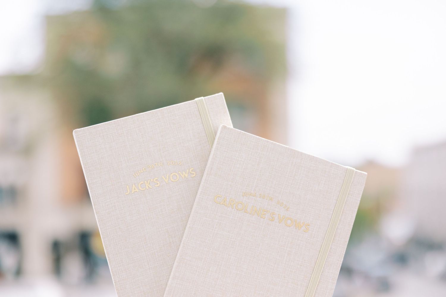 A blurry background image with out-of-focus white or cream colored papers or documents spread across the frame.