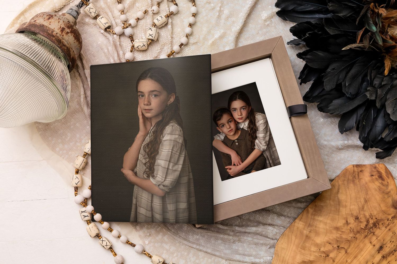 Two vintage-style photographs in warm sepia tones displayed on textured fabric with dark floral decorative elements.