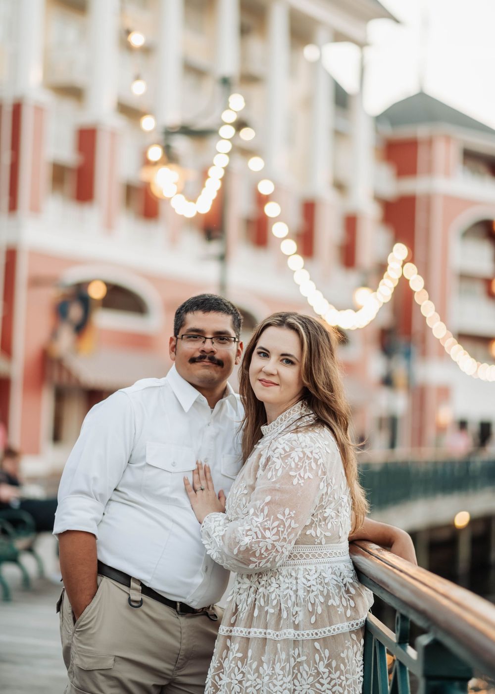 Gillian & Miles' anniversary photos at Disney Boardwalk. Gillian in white lace Ivy City Co dress, on the boardwalk. Cred: LexTakePix