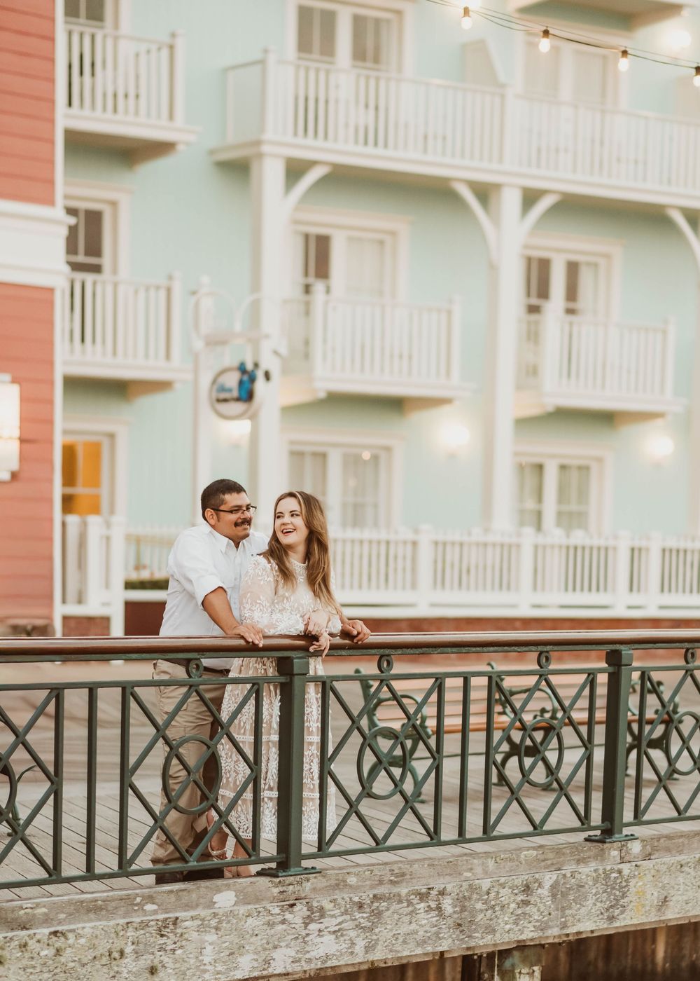 Gillian & Miles' anniversary photos at Disney Boardwalk. Gillian in white lace Ivy City Co dress, smiling. Cred: LexTakePix