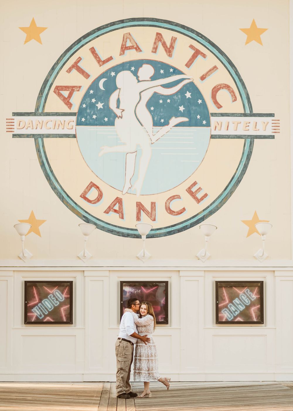 Gillian & Miles' anniversary photos at Disney Boardwalk. Gillian in white lace Ivy City Co dress, in front Atlantic Dance. Cred: LexTakePix
