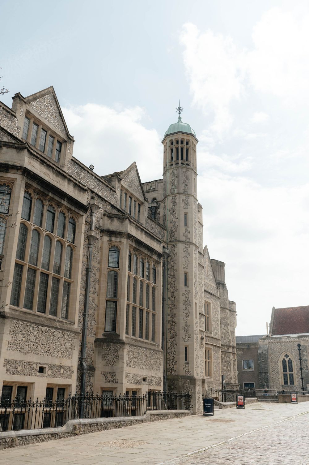 Gothic revival architecture of a historic church or university building with tall spire and stone facade.