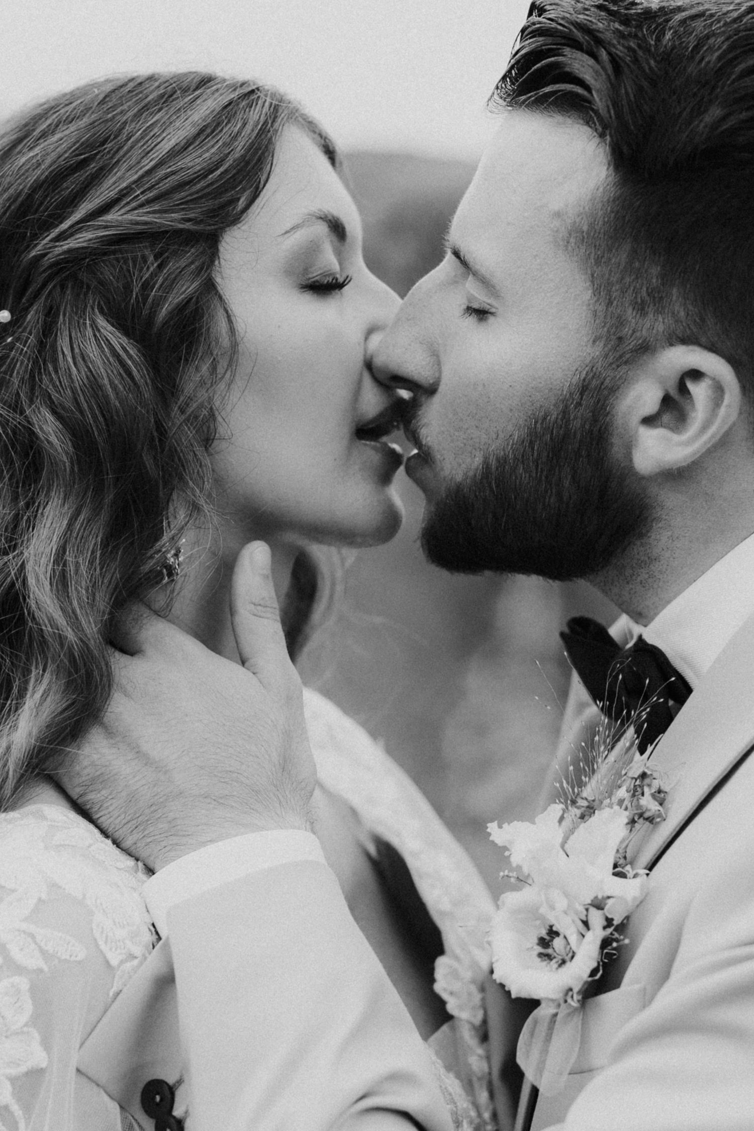 A tender autumn embrace captured during a wedding photoshoot with fall foliage.