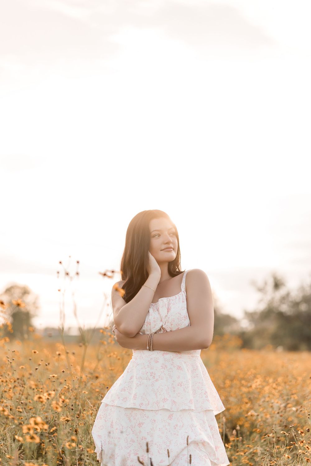 Joyful summer portraits in a blooming meadow of wildflowers at sunset.