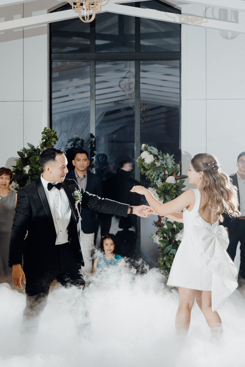 Bride and groom dance at a wedding reception with fog machine captured by Apertured Media Auckland Wedding Photographer.