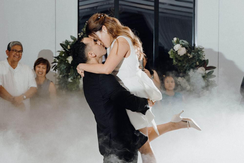 A couple shares their first dance as newlyweds surrounded by romantic fog captured by Apertured Media Auckland Wedding Photographer.