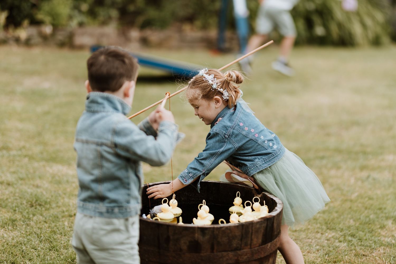 Two play hook a duck at wedding reception