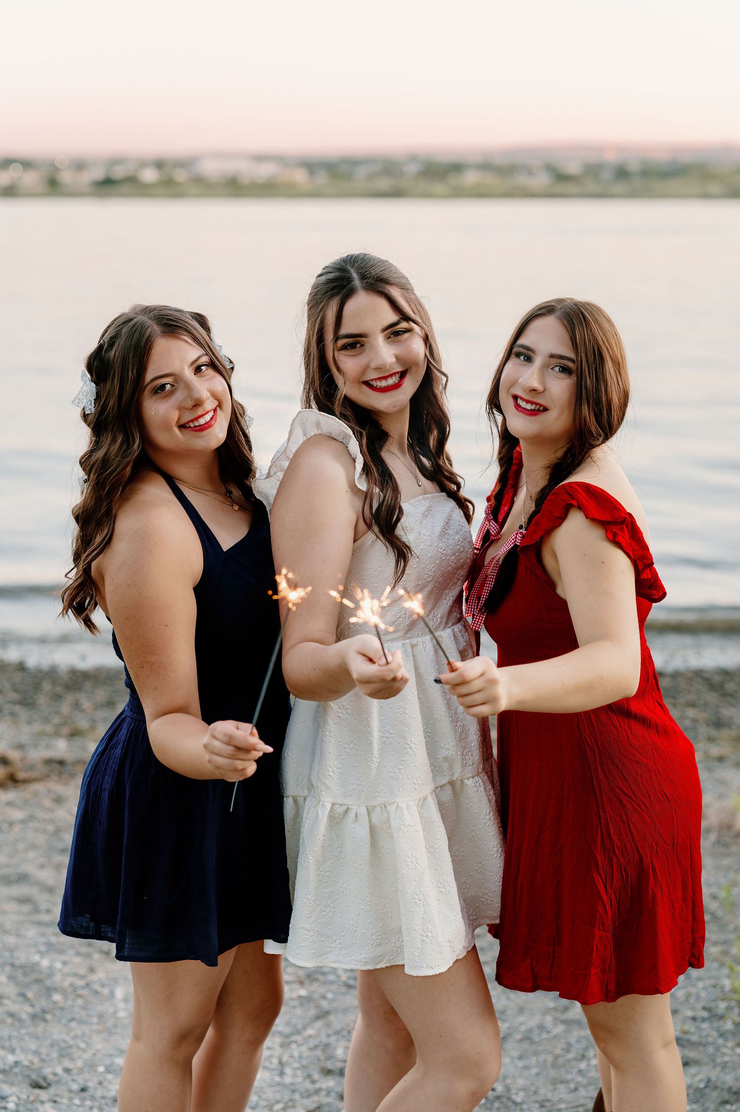 Patriotic senior pictures with sparklers by the river