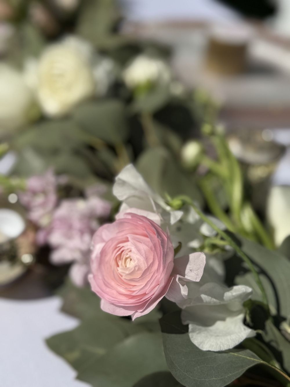 Pink floral arrangements and table decor at baby shower planned in Columbus, Ohio