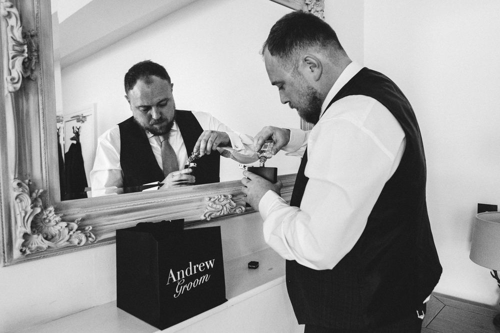 A black and white photo strip showing elegant wedding preparation moments in a bright room with mirrors.