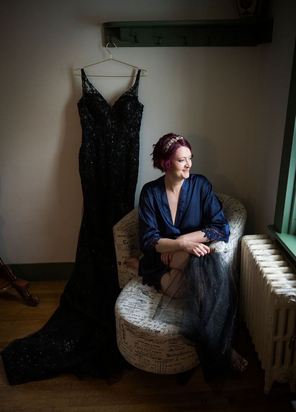 Artistic portrait series showing a figure in navy blue clothing seated in a textured armchair under dramatic window lighting.