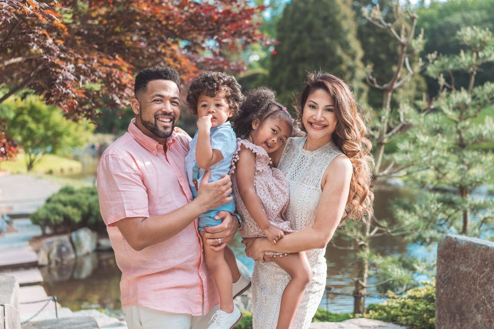 Family sharing tender moments during autumn outdoor photo session.