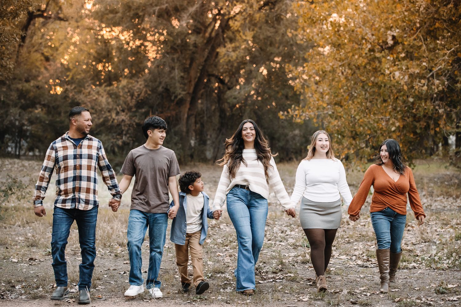 professional family photo session in rocky mountains in colorado. family of 6 posing in the fall mountains liz rivas illuminating images