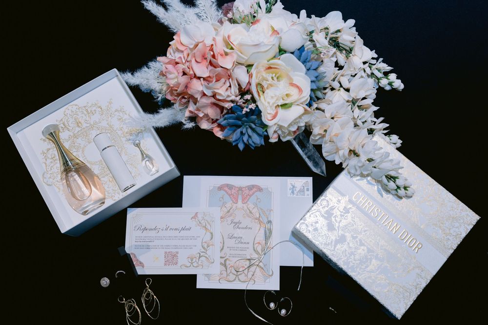 Wedding stationery set with pink and blue flowers featuring elegant design elements.