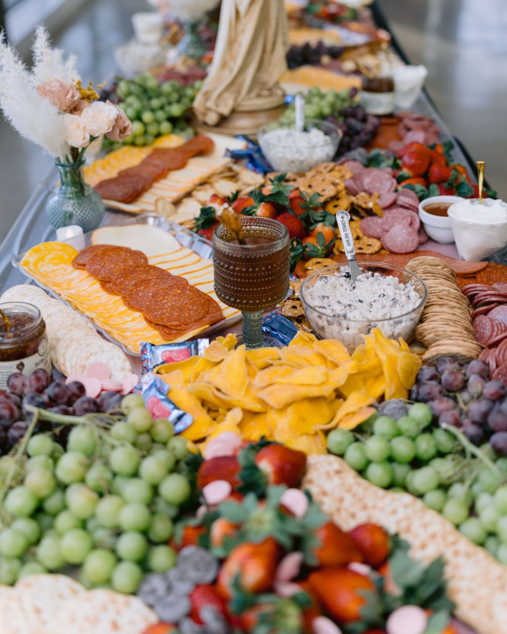 Luxurious charcuterie board with cheeses, fruits, meats and appetizers arranged for a special event.