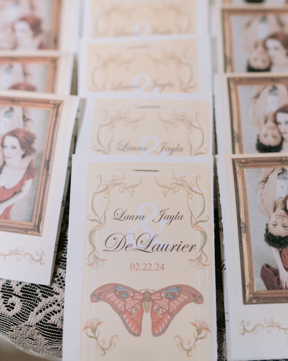 Wedding name cards with butterfly designs and vintage-style portraits arranged in rows.