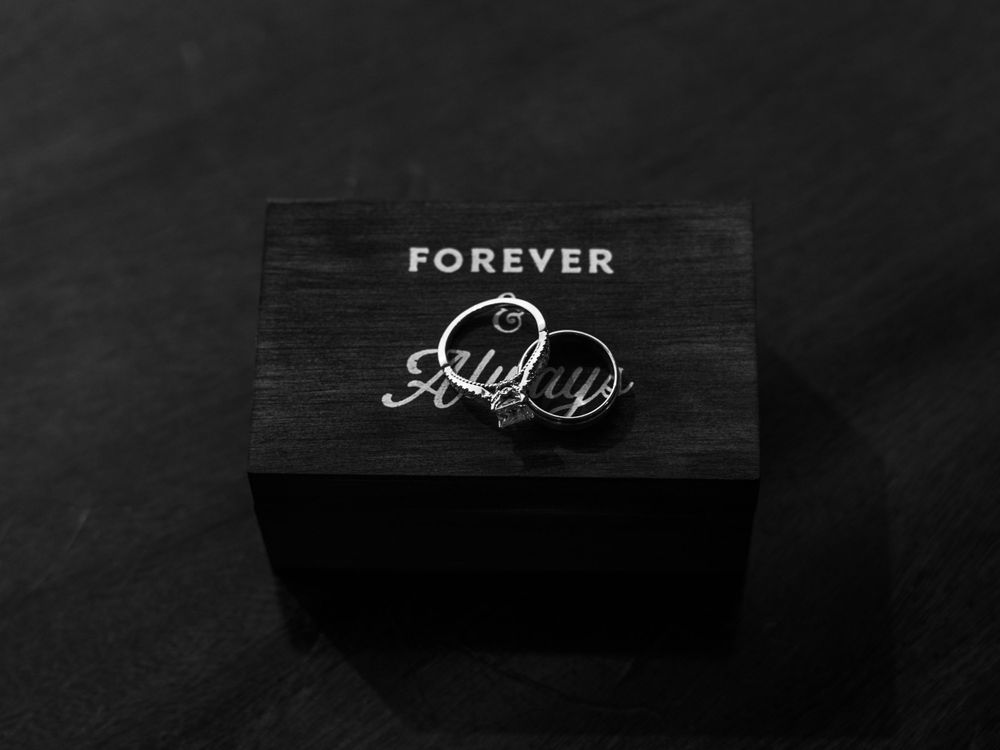 A black wooden box with the word 'FOREVER' engraved on its lid against a dark background.